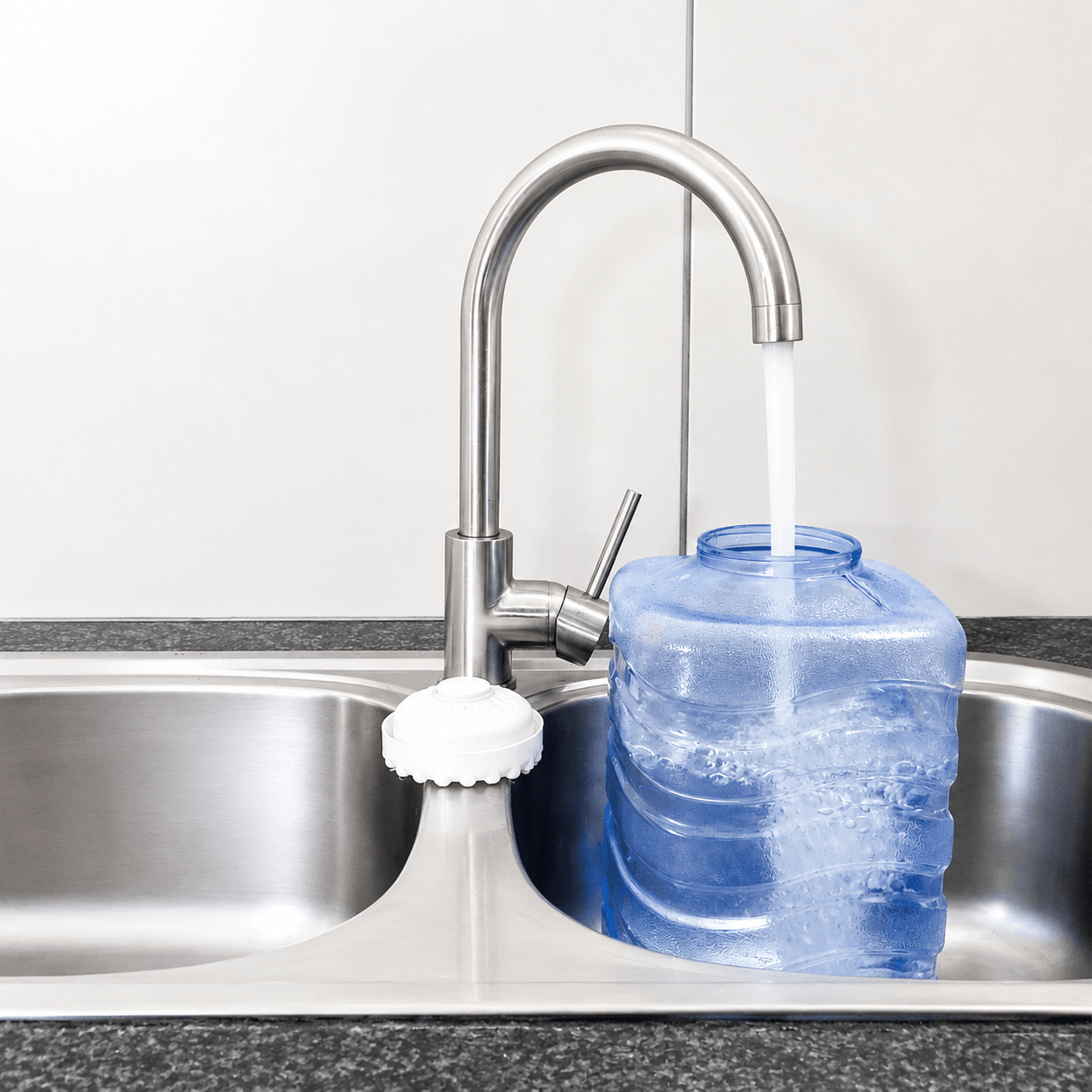 Little Luxury Vitality replacement water bottle being filled with tap water at a kitchen sink